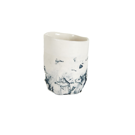 White Cup With Dark Blue Creases In Texture